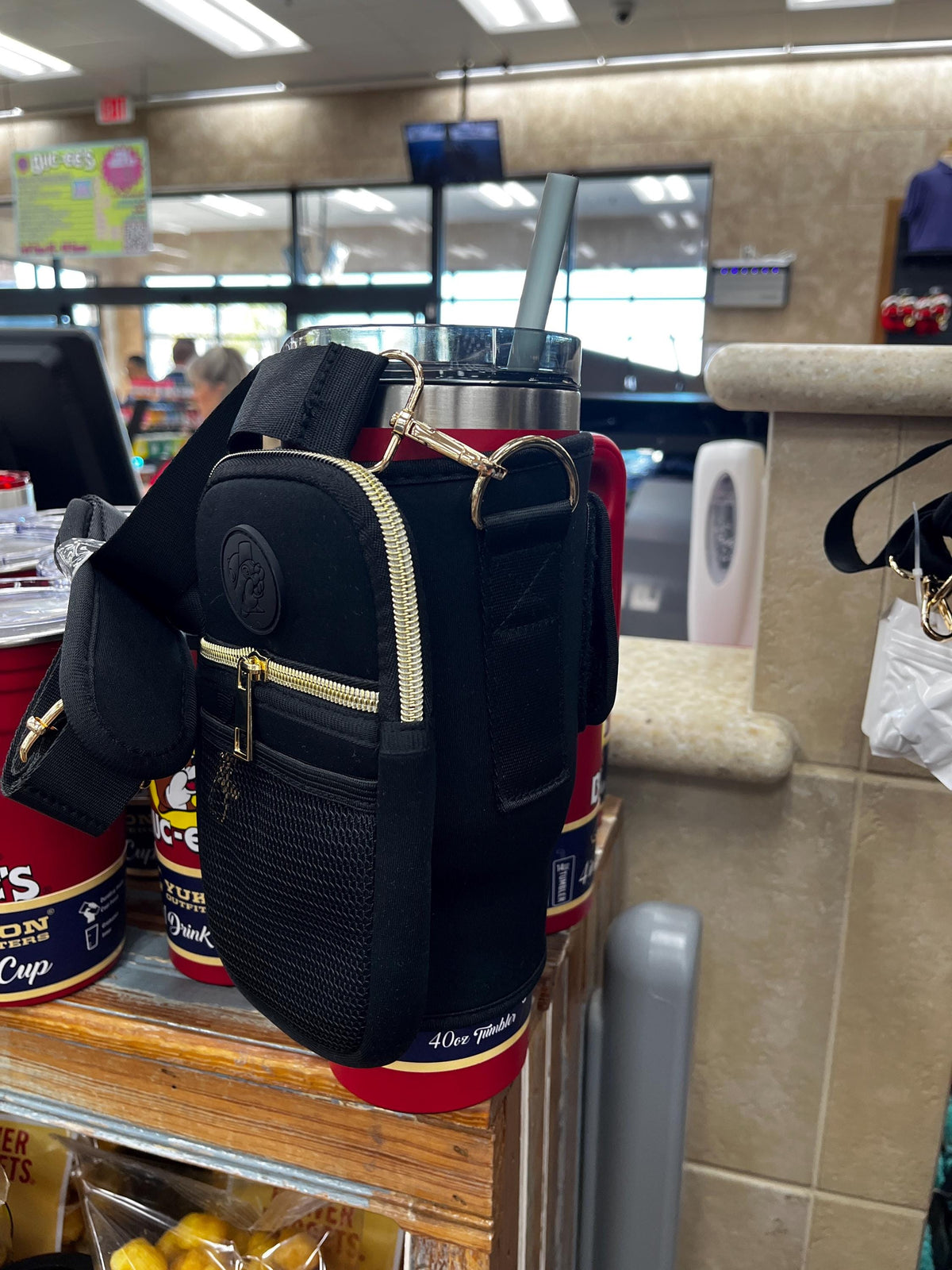 Buc-ee’s Crossbody Tumbler Bag, Black with Gold, Straw Stopper, 3 card wallet, Lipstick pocket, adjustable strap, Holds 40oz Cup with Handle